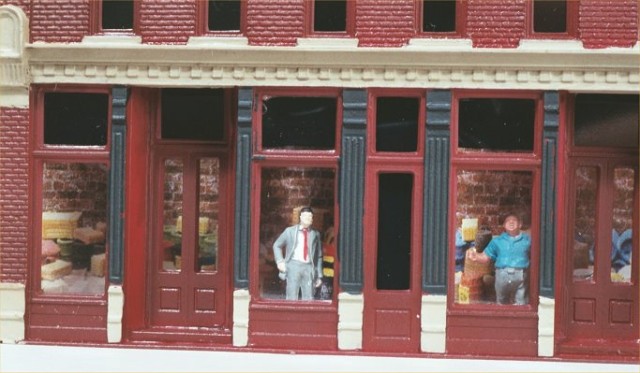 Close-up view of the model building with figures inside.