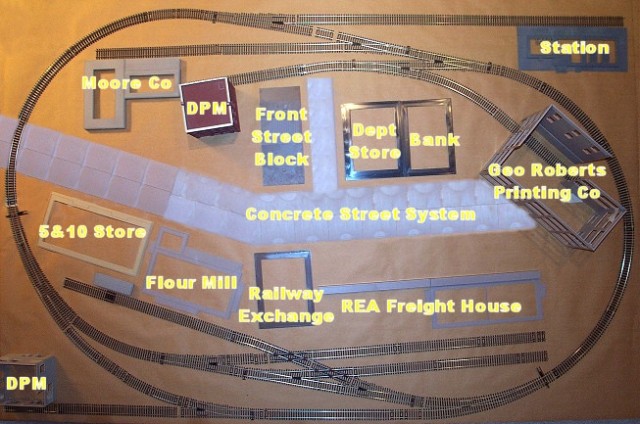 Track pieces and building foundations laid out on a sheet of paper to prove the design.