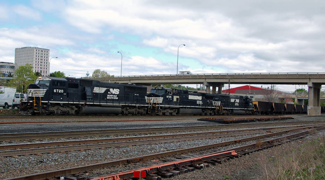 Coal empties heaed west through the yard in Altoona ... it's just passed the Juniata Shops. Notice the railroad has taken a page from modelers and built a turnout off site to be inserted in the railroad.