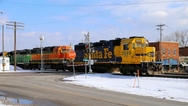 Right behind (180 degrees) the location of the previous two photos is the BNSF line to Springfield. This is the former Frisco. Here is the local; it had four engines and two covered hoppers. It does make for a colorful lash-up.