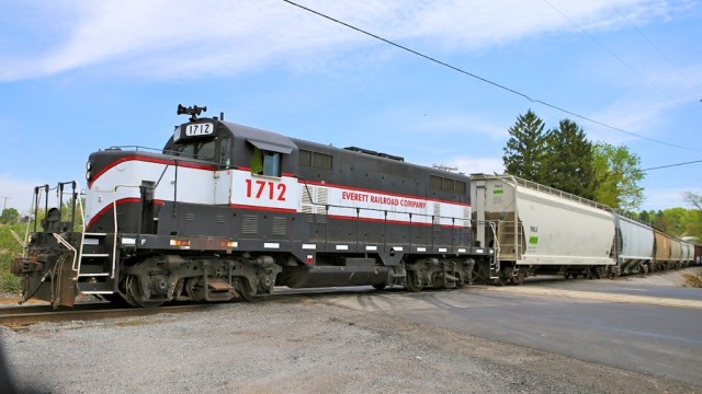 Work at Smith Transport was behind warehouses that we could not access, and here we see the train, with box cars added, leaving Smith.