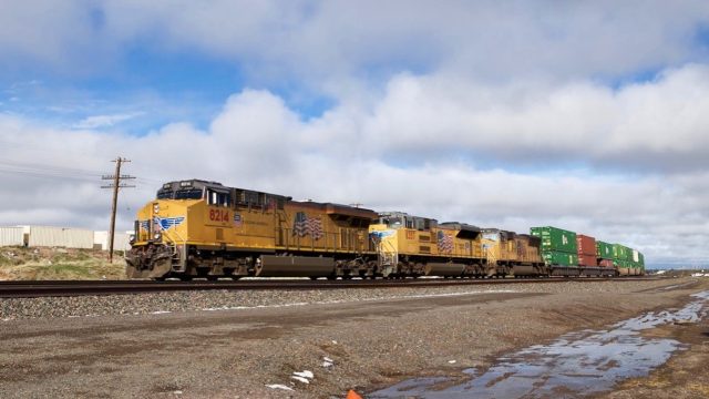 A westbound stack train behind Union Pacific power is just a couple off miles east of the Cheyenne rail yard, which is a division point on the UP. This is a high traffic area for rail fans.