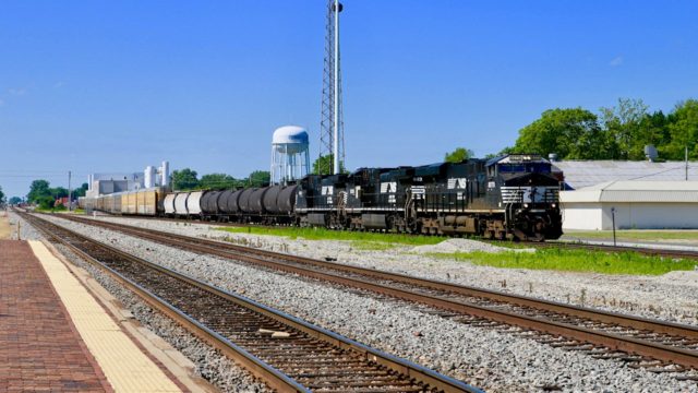 NS has just crossed the CN by the plant seen in the background, and is on its way from Louisville to St. Louis. Less than a mile ahead, it will veer off to the west and on to St. Louis. Tracks in the foreground belong to Canadian National.