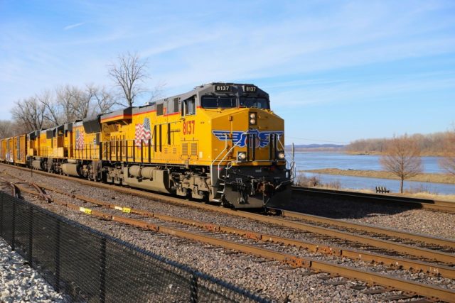 Rolling along. This east bound UP freight at track speed along the former MoPac right-of-way in Washington, Missouri. That’s the Missouri River in the background.