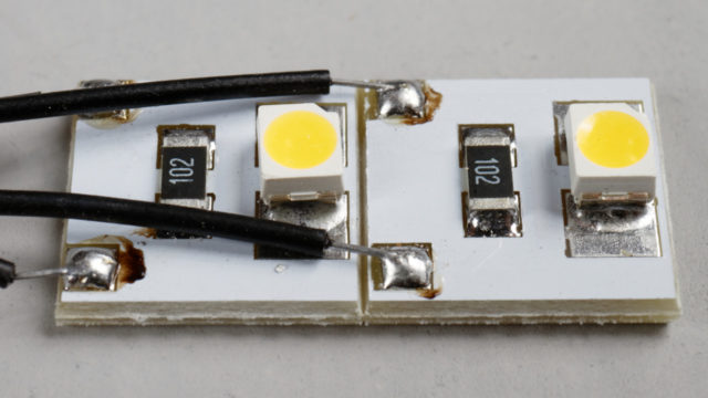 The Evemodel modules have a warm white LED and the required resistor to power it on 12 volts DC.