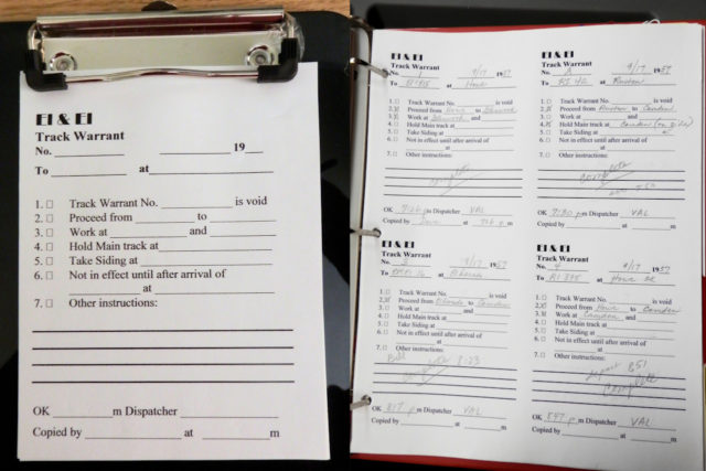 Track warrant on clipboard (left) and track warrant notebook for dispatcher (right).